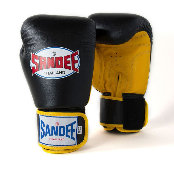 A pair of black and yellow Velcro boxing gloves with the brand logo 'SANDEE THAILAND' on the back.