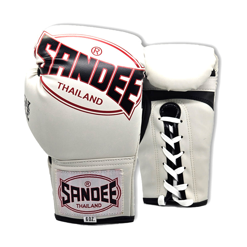 A pair of kids' boxing gloves with a lace-up closure, predominantly white with black and red accents, featuring the brand name 'Sandee' Thailand.